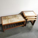 A nest of three tile topped tables together with a similar tile topped coffee table with ladder rack