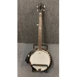 An Ozark Remo banjo with stand.