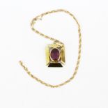 A large hallmarked 9ct yellow gold amethyst set pendant, L. 2.5cm, on a 9ct gold chain, L. 50cm.