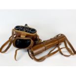 A pair of 1943 military binoculars together with a leather cased telescope.