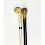 An antique carved whale bone sectional walking stick, L. 83cm, together with a horn handled