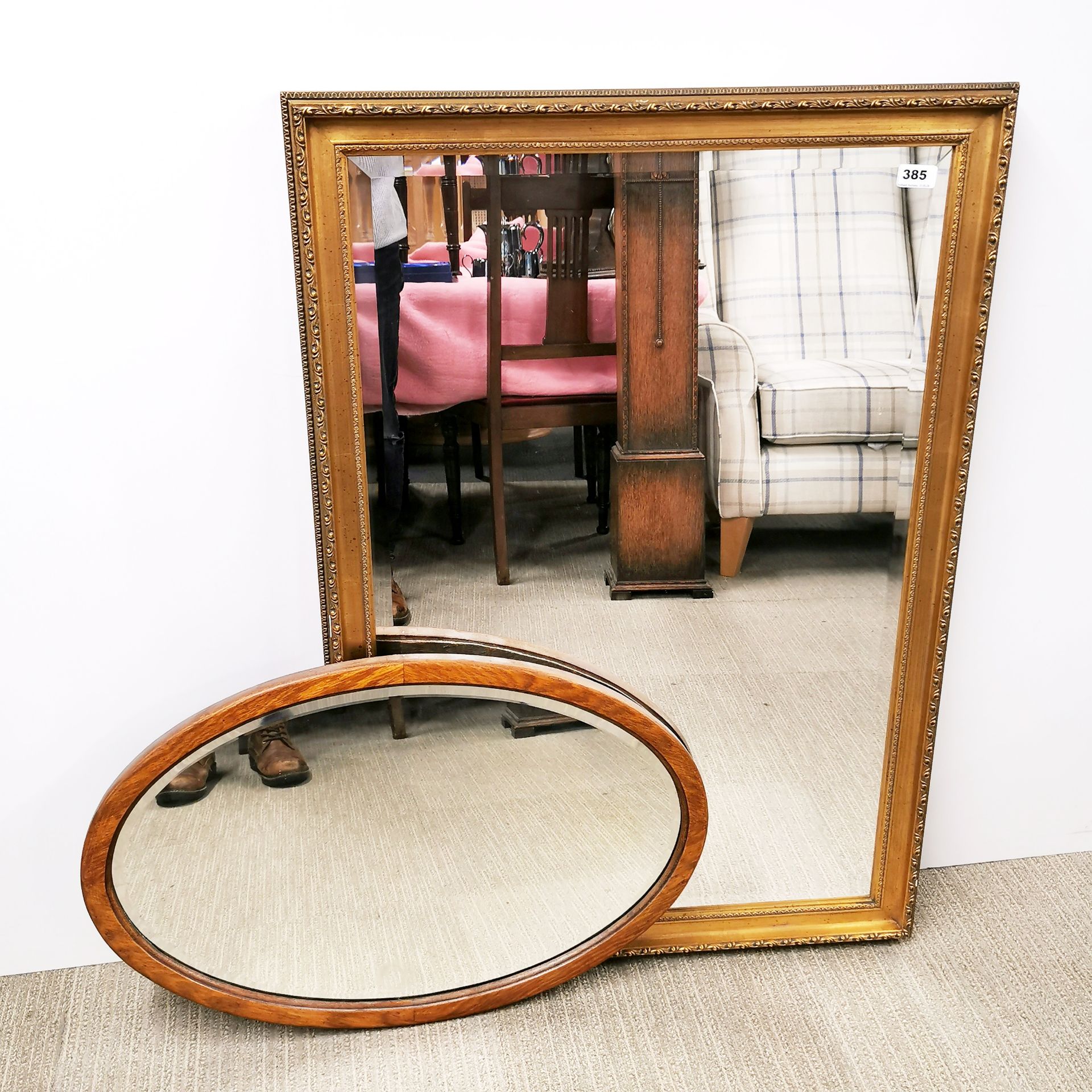 A gilt framed over mantle mirror with a further oval mirror, largest 71 x 103cm.