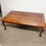 A large 20th C figured walnut veneered coffee table with cross banded inlay, 150 x 90 x 48cm.