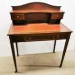 An early 20th C three drawer inlaid mahogany and leather topped writing desk, 96 x 84cm.