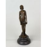 An Art Deco bronze style figure on a black marble base, H. 19cm.
