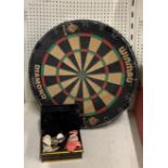 A dart board and collection of darts.
