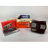 A boxed bakelite Viewmaster viewer and collection of discs together with a pair of folding pocket