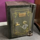 A 19th/early 20th C cast iron floor safe with brass plaque titled 'The Defiance Safe.' Two keys