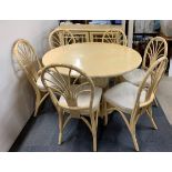 A painted circular cane and wood pedestal table with extension leaf and matching mirrored cabinet,