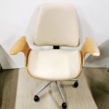 A stylish faux leather adjustable, swivel office/desk chair on wheels, H. 94cm.