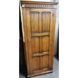 An early 20th C carved oak wardrobe, 182 x 72cm.