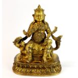 A Tibetan gilt bronze figure of a guardian deity, H. 23cm.