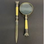 A silver plate mounted letter opener, L. 27.5cm, and magnifying glass.