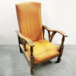 An interesting 20th century oak reclining armchair with orange upholstery, H. 90cm.