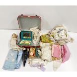An Armand Marseille composotion doll with a vanity case of doll related and fabric items.