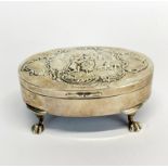 A lovely hallmarked silver relief decorated silk lined box mounted on four claw feet, 12 x 8 x 4.