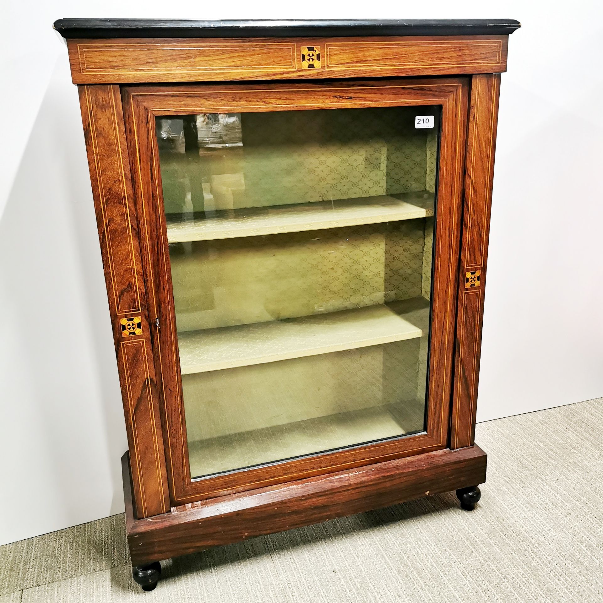 A 20th C stained mahogany display cabinet with green fitted interior and geometric inlaid