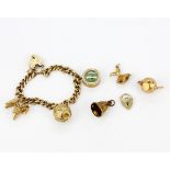 A hallmarked 9ct gold charm bracelet with additional loose charms, clasp A/F. Three charms without