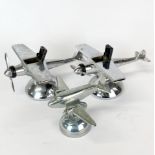 Two chromium plated airplane cigarette lights, W. 12.5cm together with a pewter Fossil model of an