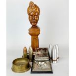 A carved wood and metal desk figure of a gentleman wearing a turban together with an engraved Indian