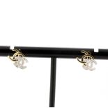 A pair of 18ct yellow and white gold diamond set stud earrings, L. 1cm.