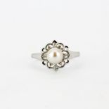 A 9ct white gold cultured pearl and diamond set ring, (P.5).