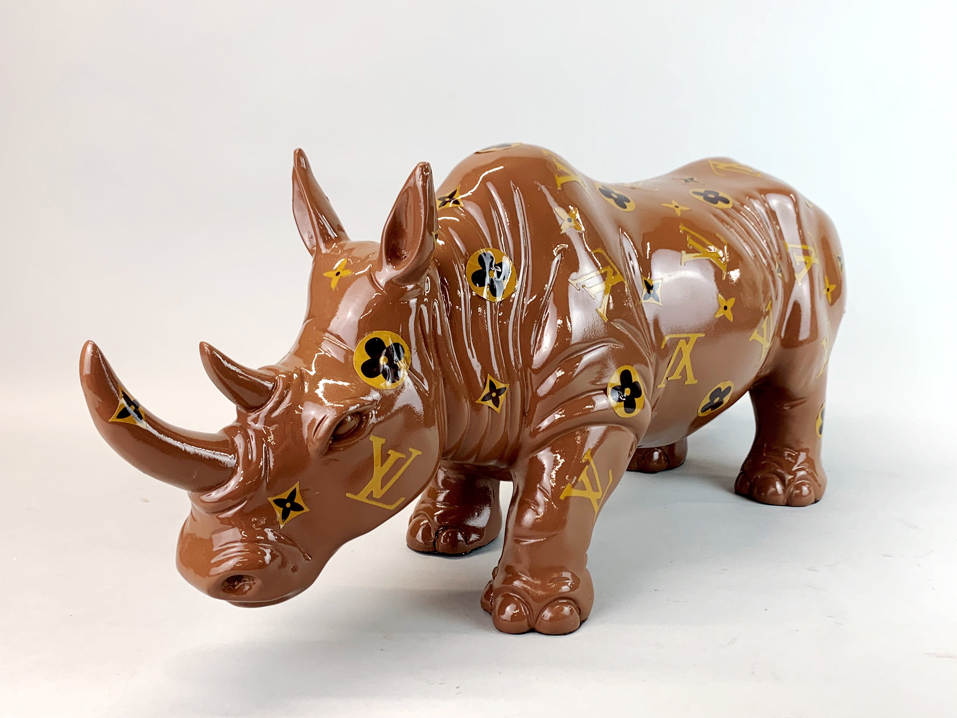 A composition rhino sculpture with applied paper decoration, H. 23cm, L. 50cm. - Image 3 of 3