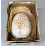 A mid 20th century worked sugar egg, with original box, H. 11cm.