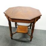 A 20th century octagonal, two-tier side table with turned wooden legs, H. 67cm W. 75cm.