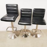 Three chromium plated and faux leather revolving, adjustable kitchen/bar chairs, H. 93cm.