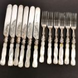 An antique set of desert knives and forks with carved mother of pearl handles.