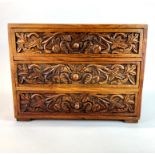 A carved hard wood three drawer box, 35 x 26 x 27cm.