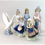 Three Lladro porcelain figurines of children with flowers, a Lladro swan and three Nao porcelain