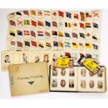 A collection of cigarette silk flags of the world sewn together with three albums of cigarette