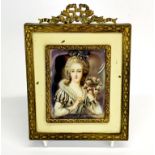 A gilt framed hand painted portrait miniature of a lady, frame size 12 x 16cm.