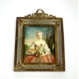 An early 20th century gilt metal mounted hand painted miniature of a young woman, frame size 14 x