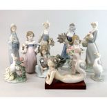 A quantity of Lladro porcelain figures and a further porcelain lady figurine, tallest H. 24cm.