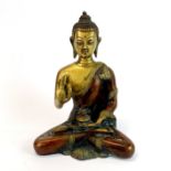 An Tibetan bronze figure of a seated Buddha, H. 19cm.