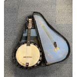 A cased Melody Major banjo.