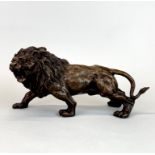 A bronze lion sculpture, L. 30cm, H. 15cm.