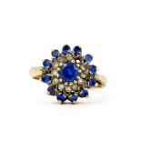A hallmarked 9ct yellow gold cluster ring set with round cut synthetic spinels, (N). One white