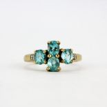 A hallmarked 9ct yellow gold ring set with oval cut apatite and diamonds shoulders, (N). Minor