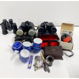 Three pairs of binoculars and other items.