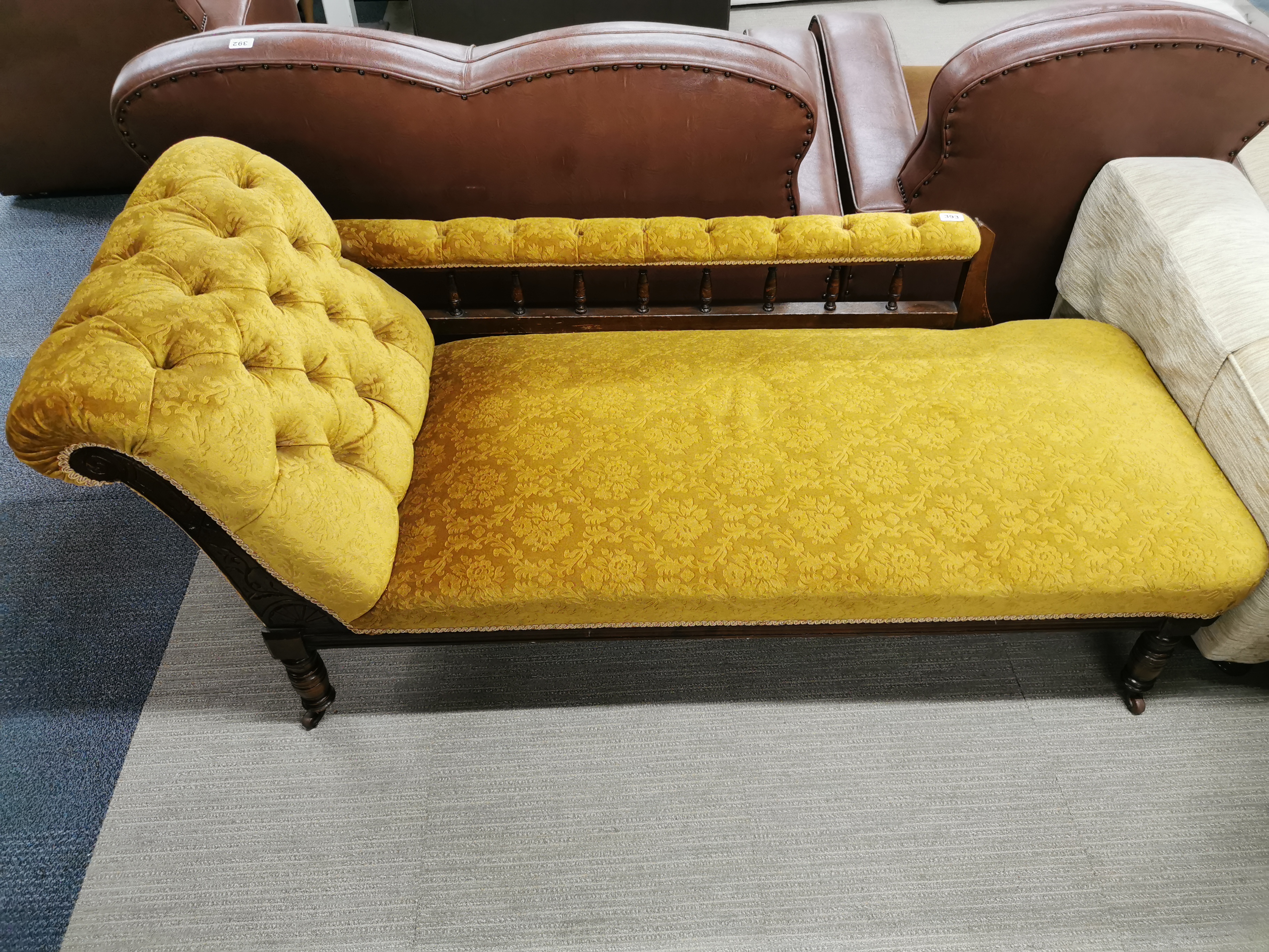 A carved mahogany and button backed, floral upholstered chaise longue on castors, L. 165cm. One