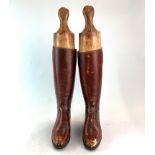 A pair of antique leather riding boots stamped inside 4921 6D.Possibly by Horace Batton, with wooden