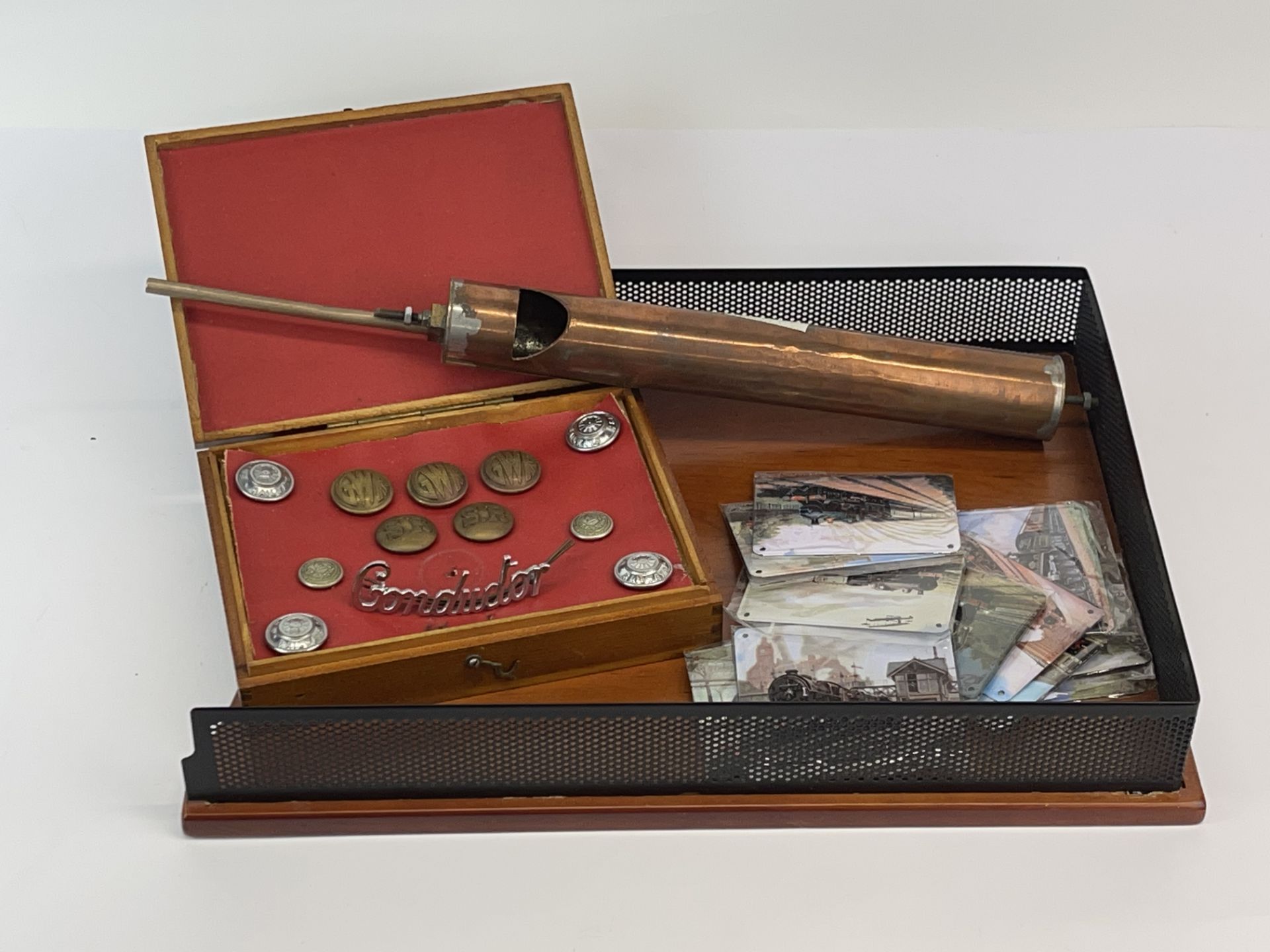 A group of railway related items including a copper steam whistle and buttons.