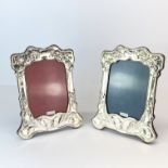 A pair of wooden backed hallmarked silver Art Nouveau style photo frames, H. 21cm.