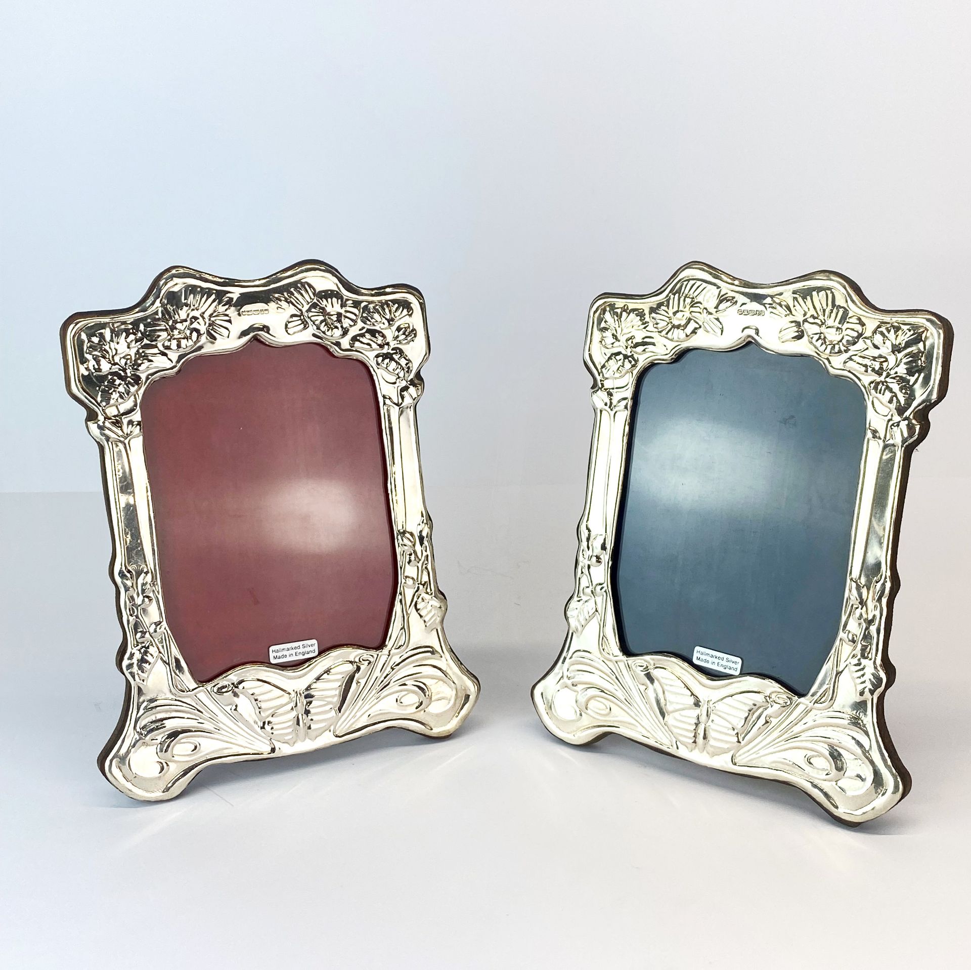 A pair of wooden backed hallmarked silver Art Nouveau style photo frames, H. 21cm.