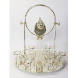 An unusual silver plated parrot on a stand liqueur decanter and shot glasses with revolving frame