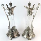 A superb pair of Art Nouveau silver plated jugs by WMF, H. 41cm. One with repair to handle.